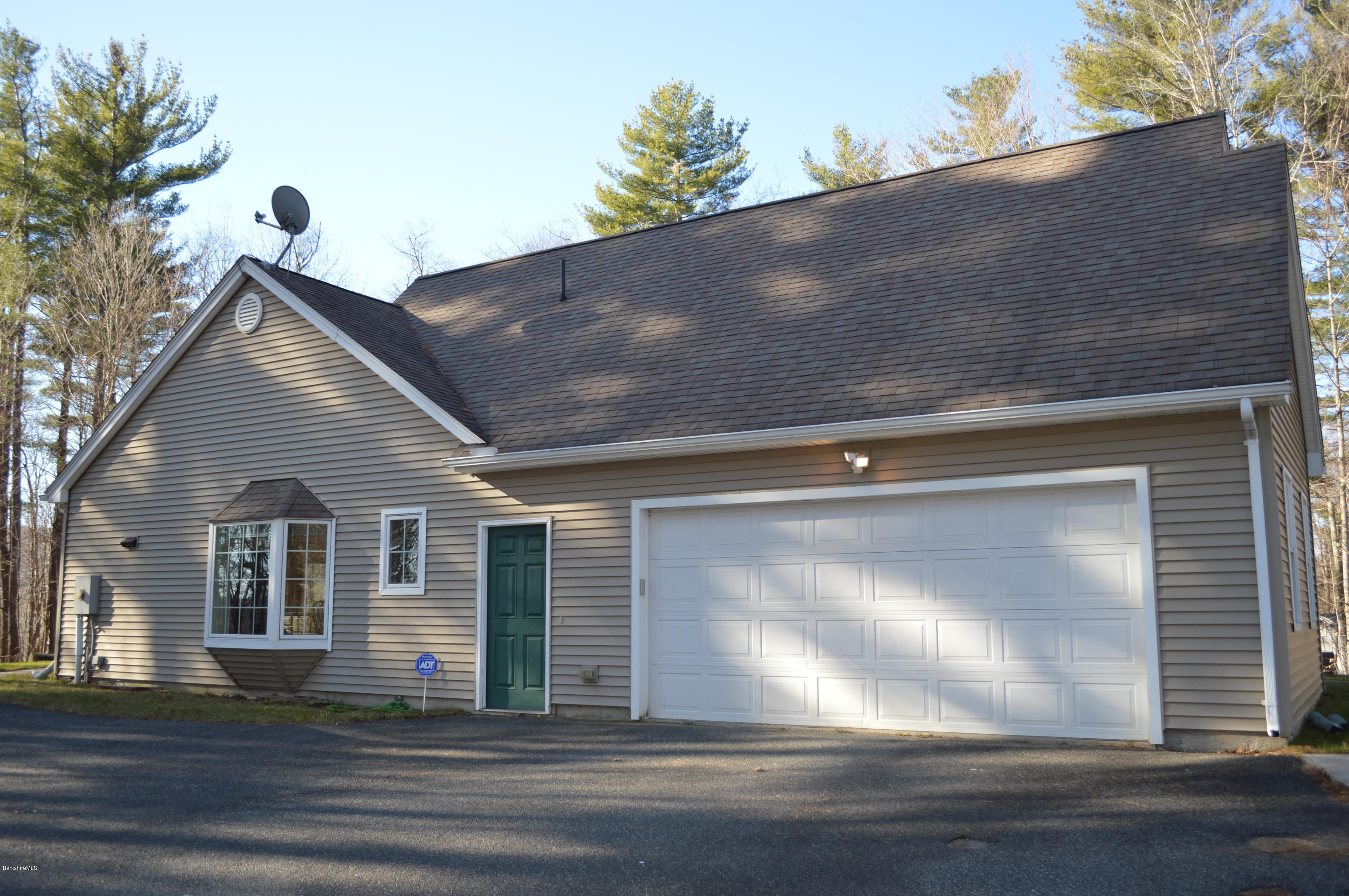2307 Jacobs Ladder Road Becket, MA 01223 - Photo 49 of 55 a view of a house with a small yard and large tree