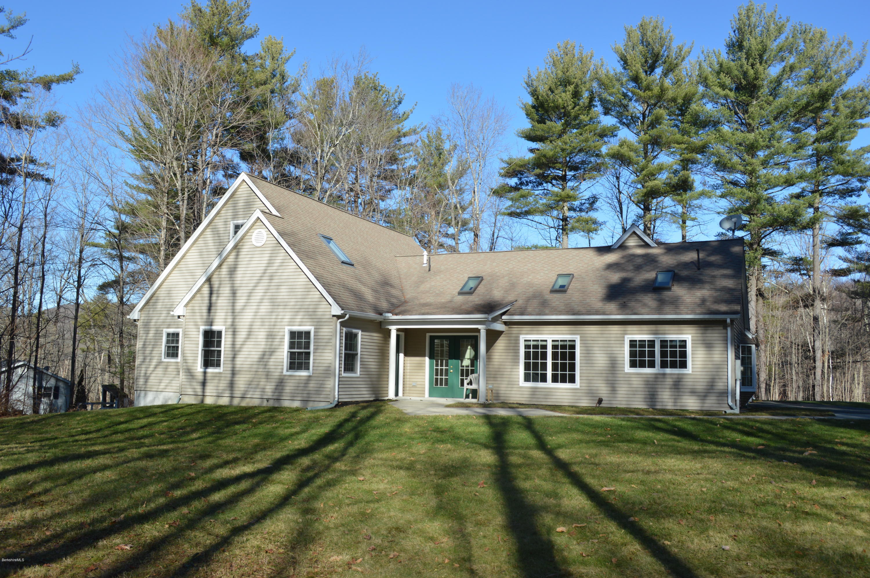 2307 Jacobs Ladder Road Becket, MA 01223 - Photo 7 of 55 a view of a yard in front of a house with a large tree