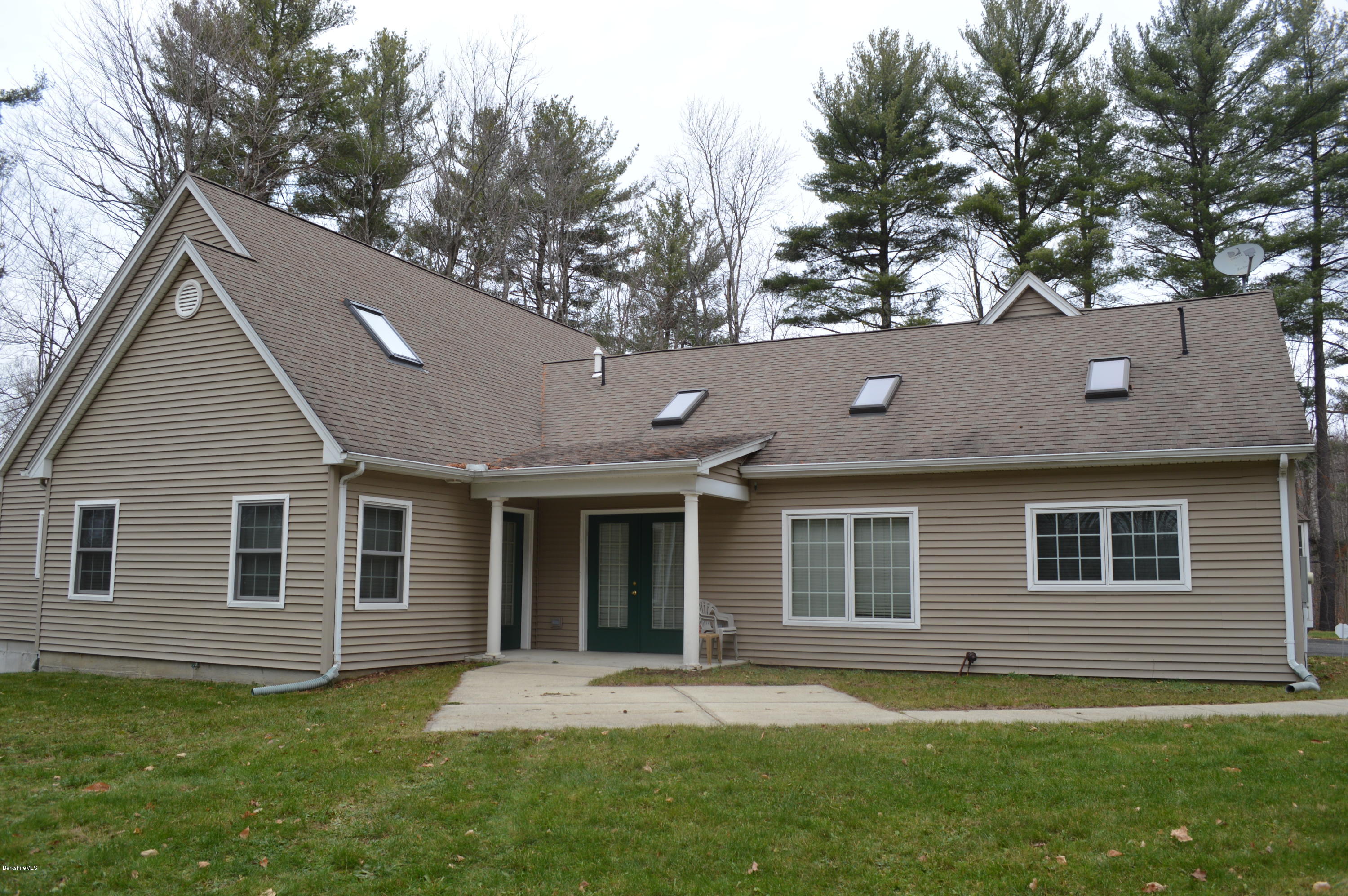 2307 Jacobs Ladder Road Becket, MA 01223 - Photo 9 of 55 a backyard of a house with potted plants and large tree