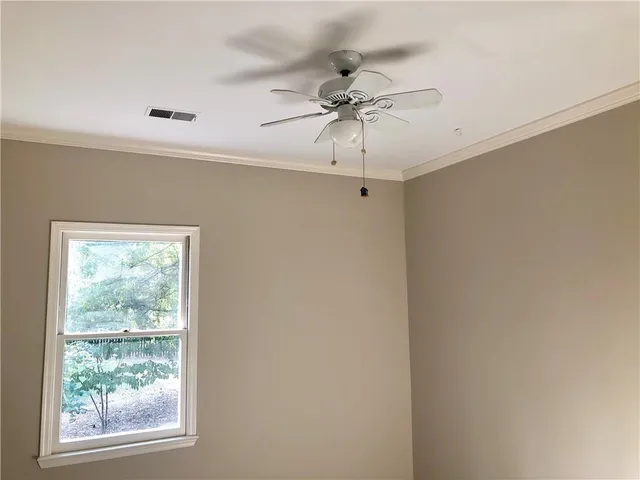 a view of a room with a window and a fan