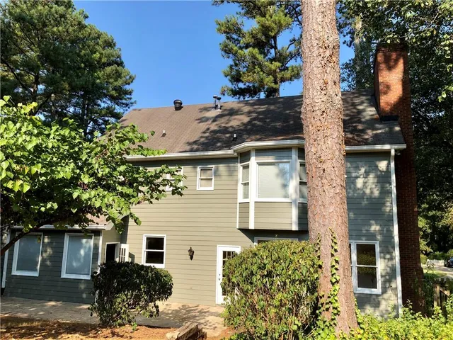 front view of a house with a tree