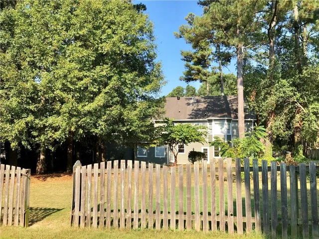 a front view of a house with a street