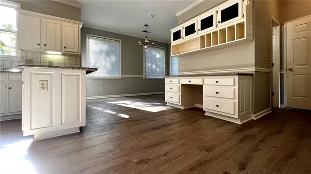 a kitchen with stainless steel appliances granite countertop a refrigerator and a stove