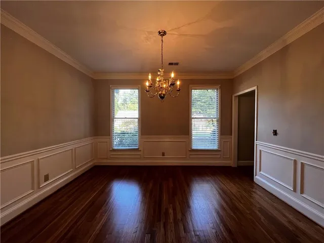 a view of room with wooden floor and fan