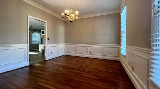 a view of a livingroom with wooden floor and staircase