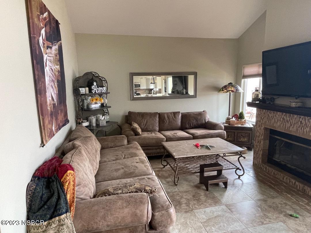 1108 Honeysuckle Way Lompoc, CA 93436 - Photo 12 of 54 a living room with furniture a flat screen tv and a fireplace