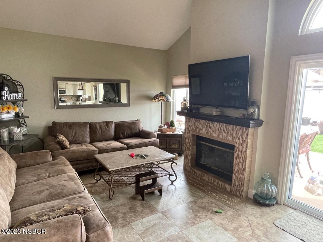 1108 Honeysuckle Way Lompoc, CA 93436 - Photo 13 of 54 a living room with furniture a flat screen tv and a fireplace