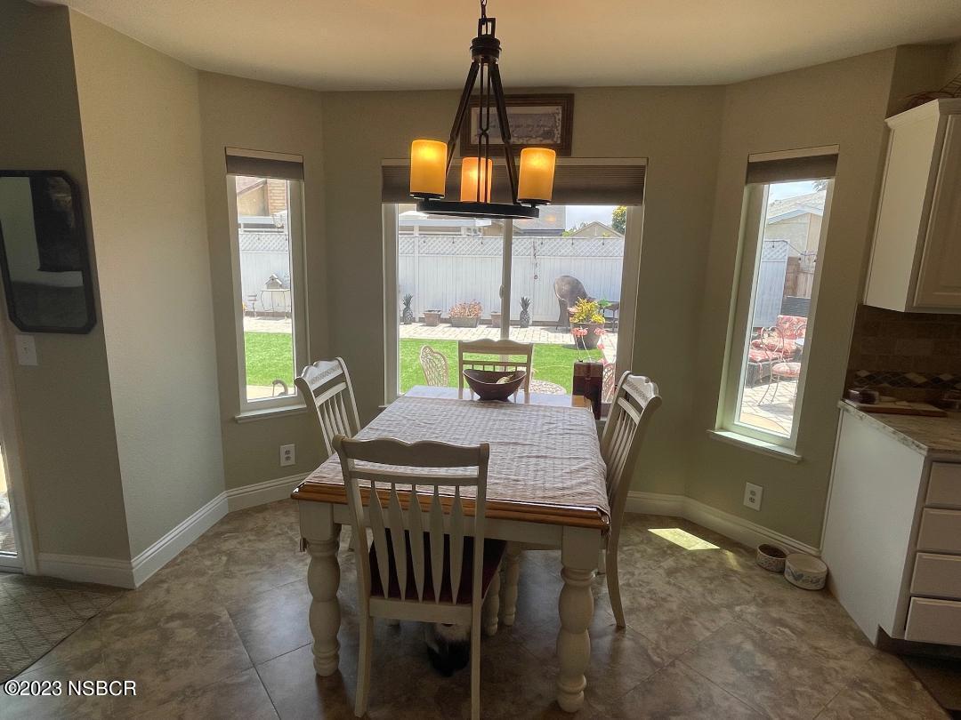 1108 Honeysuckle Way Lompoc, CA 93436 - Photo 17 of 54 a dining room with furniture a chandelier and window