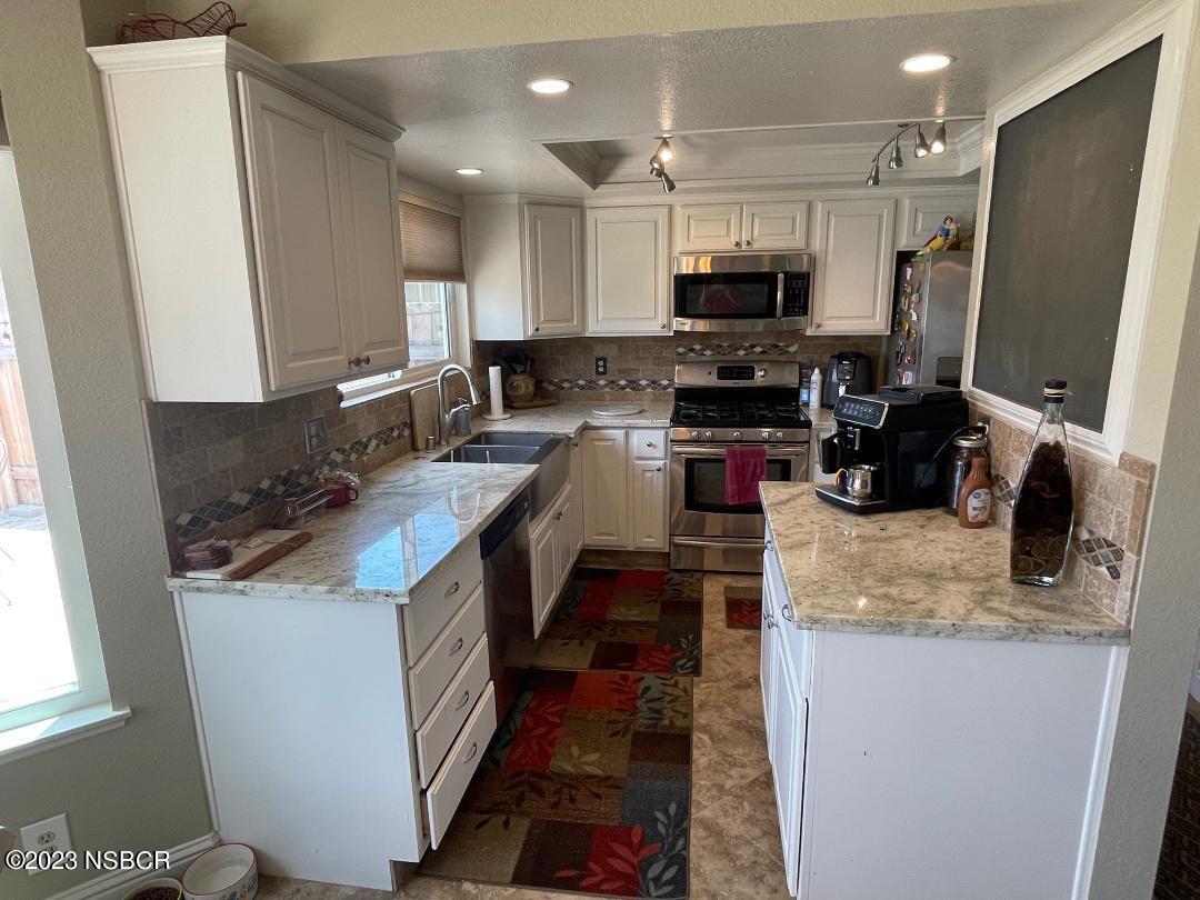 1108 Honeysuckle Way Lompoc, CA 93436 - Photo 18 of 54 a kitchen with sink a microwave a stove and refrigerator