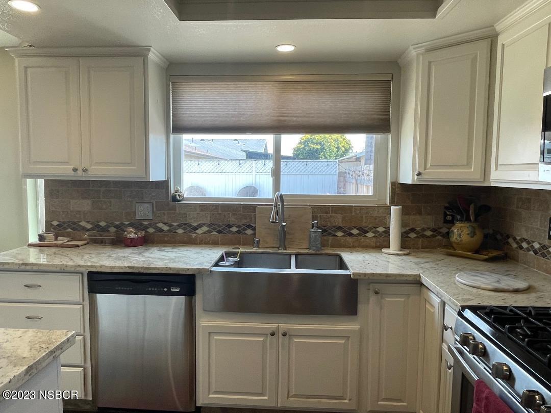 1108 Honeysuckle Way Lompoc, CA 93436 - Photo 20 of 54 a kitchen with a sink stove top oven and cabinets