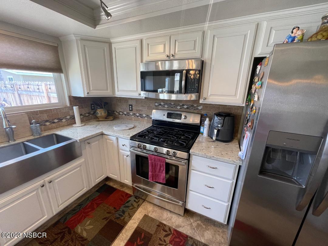 1108 Honeysuckle Way Lompoc, CA 93436 - Photo 21 of 54 a kitchen with stainless steel appliances a stove a sink and a refrigerator