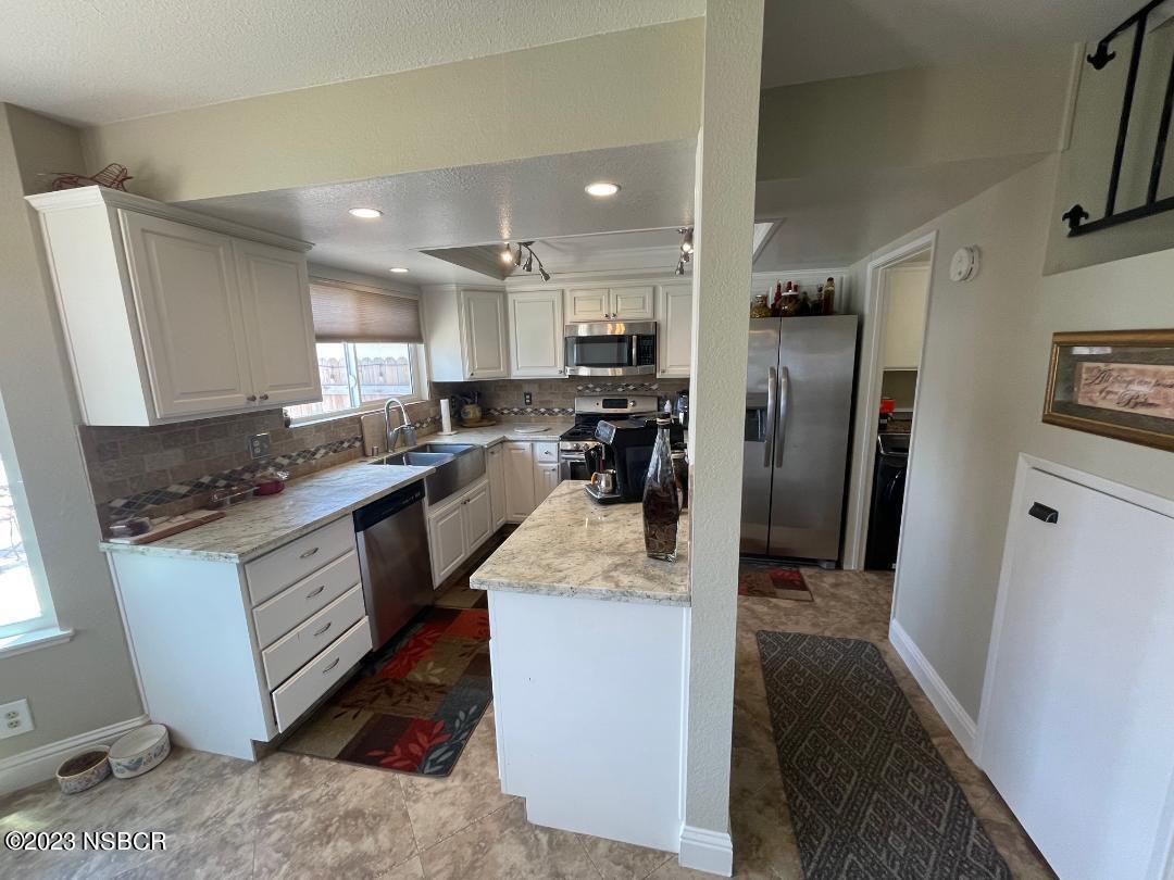 1108 Honeysuckle Way Lompoc, CA 93436 - Photo 22 of 54 a kitchen with stainless steel appliances granite countertop a refrigerator a stove a sink and a microwave