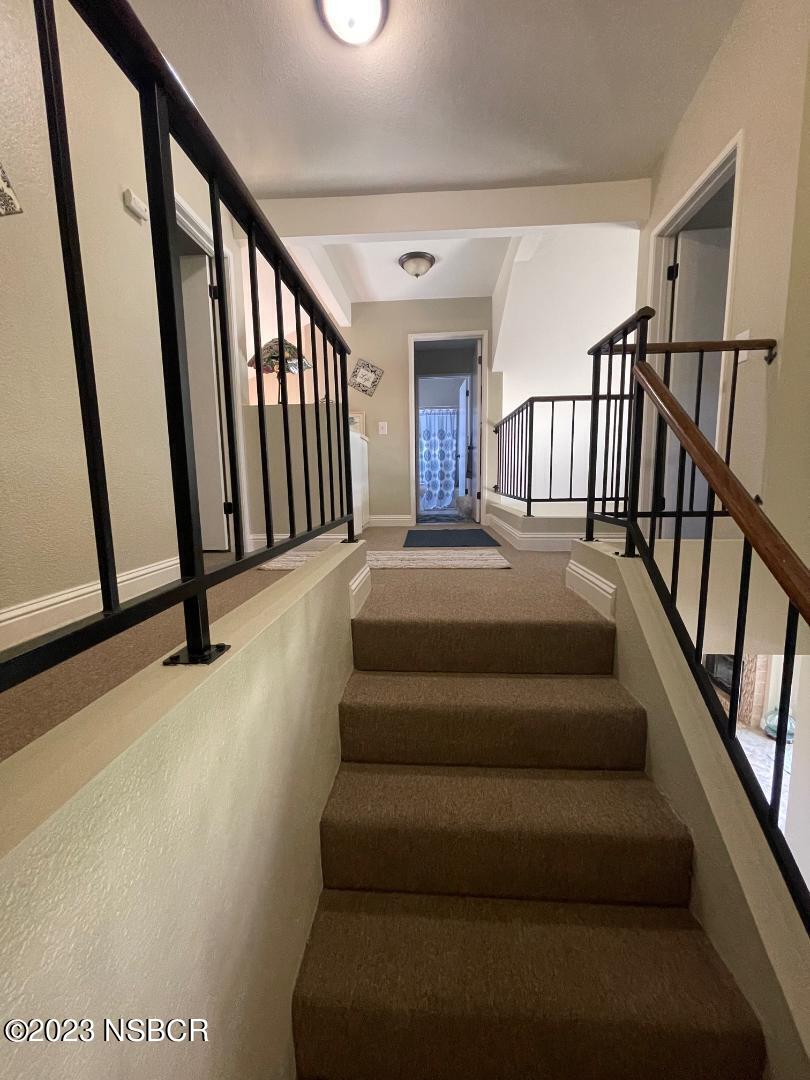 1108 Honeysuckle Way Lompoc, CA 93436 - Photo 27 of 54 a view of staircase with lots of frames on wall