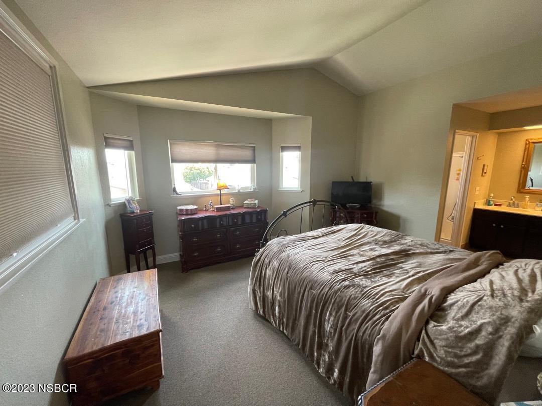 1108 Honeysuckle Way Lompoc, CA 93436 - Photo 28 of 54 a bedroom with a bed and a mirror