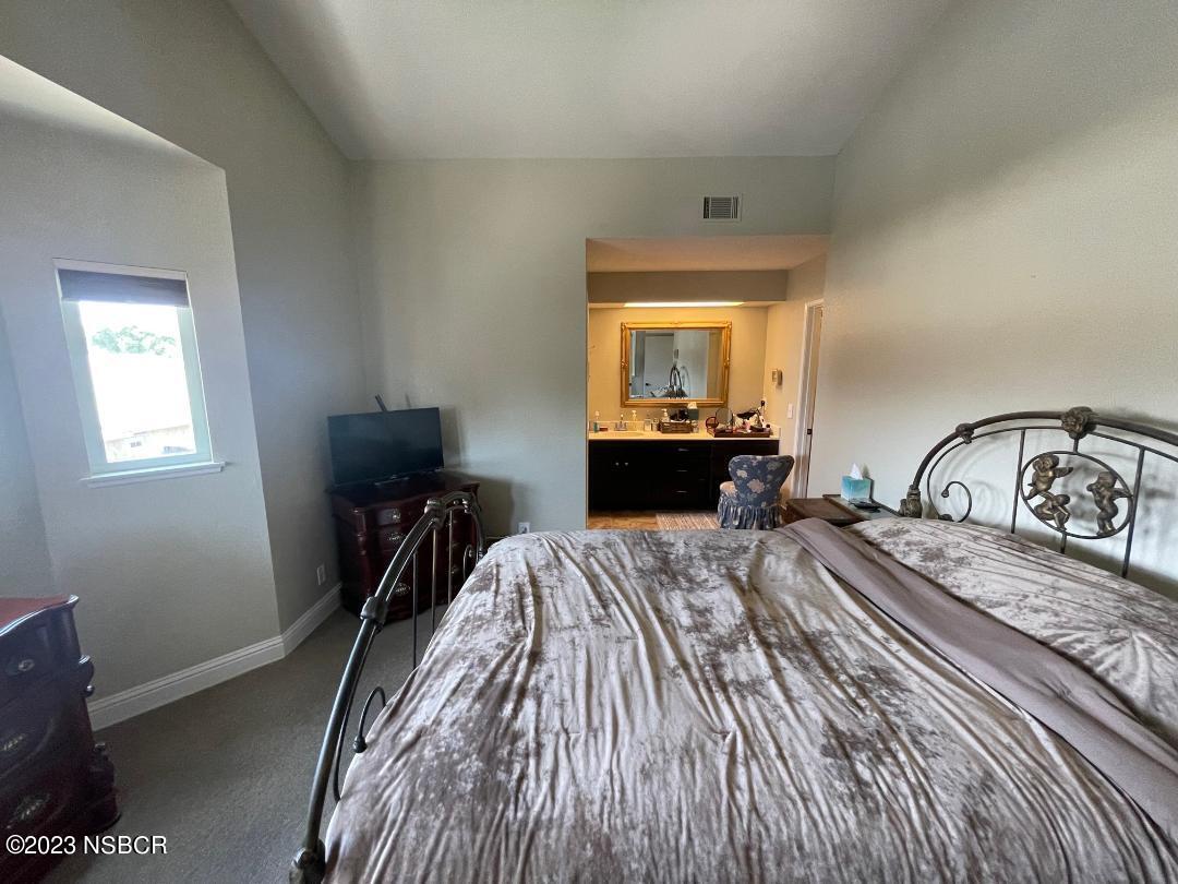 1108 Honeysuckle Way Lompoc, CA 93436 - Photo 30 of 54 a bedroom with a bed and a dresser next to a window