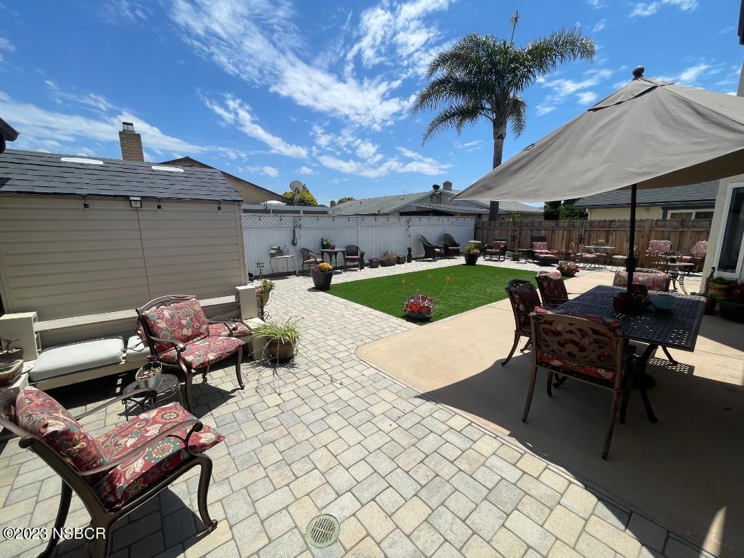1108 Honeysuckle Way Lompoc, CA 93436 - Photo 47 of 54 a view of a patio with table and chairs under an umbrella