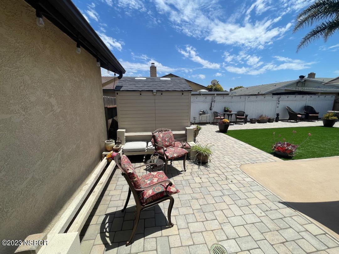 1108 Honeysuckle Way Lompoc, CA 93436 - Photo 48 of 54 a view of a patio with table and chairs and potted plants