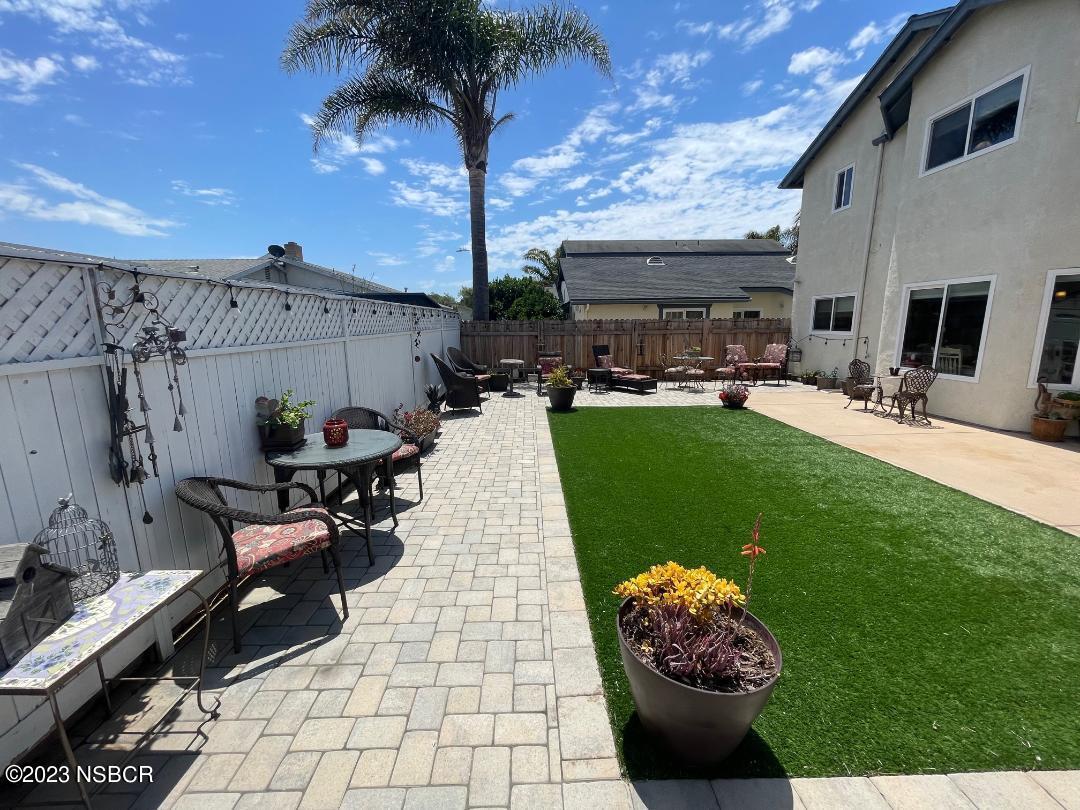 1108 Honeysuckle Way Lompoc, CA 93436 - Photo 50 of 54 a view of a patio with table and chairs potted plants with wooden floor