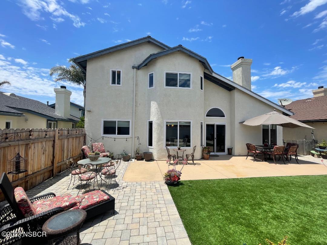 1108 Honeysuckle Way Lompoc, CA 93436 - Photo 53 of 54 a view of a white house with a yard patio and fire pit