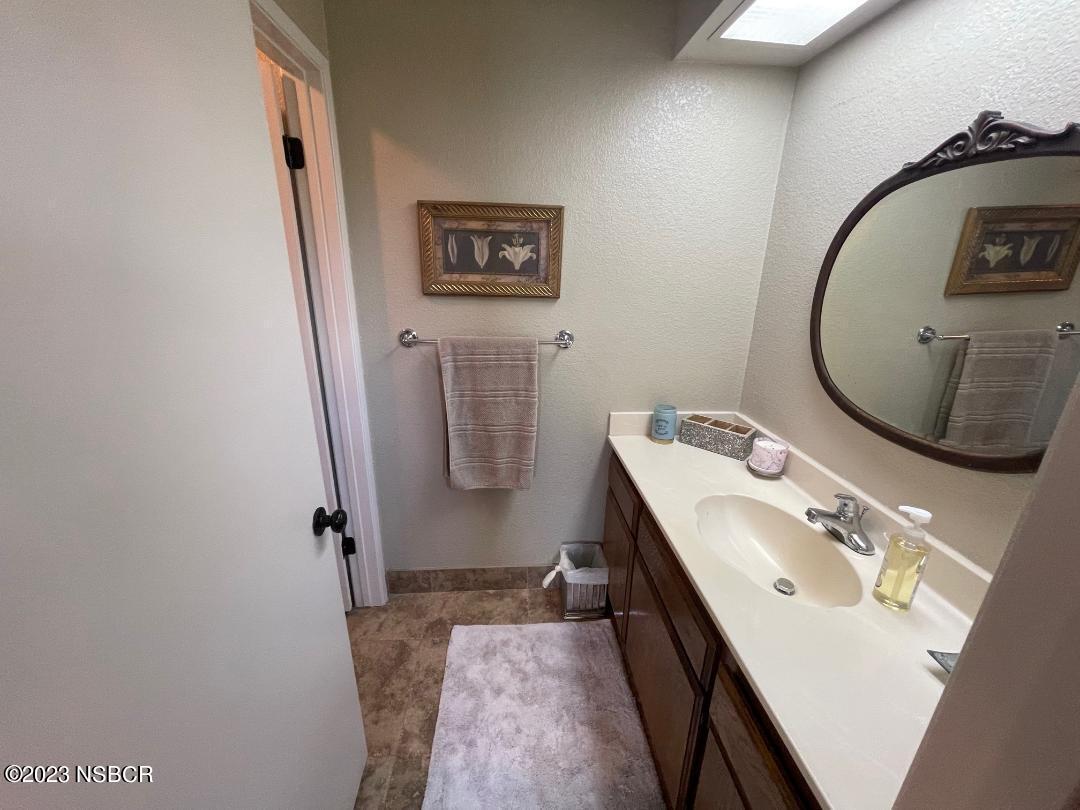 1108 Honeysuckle Way Lompoc, CA 93436 - Photo 7 of 54 a bathroom with a sink a mirror and a toilet