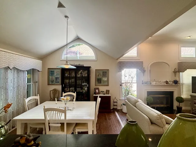 a living room with furniture a fireplace and a chandelier