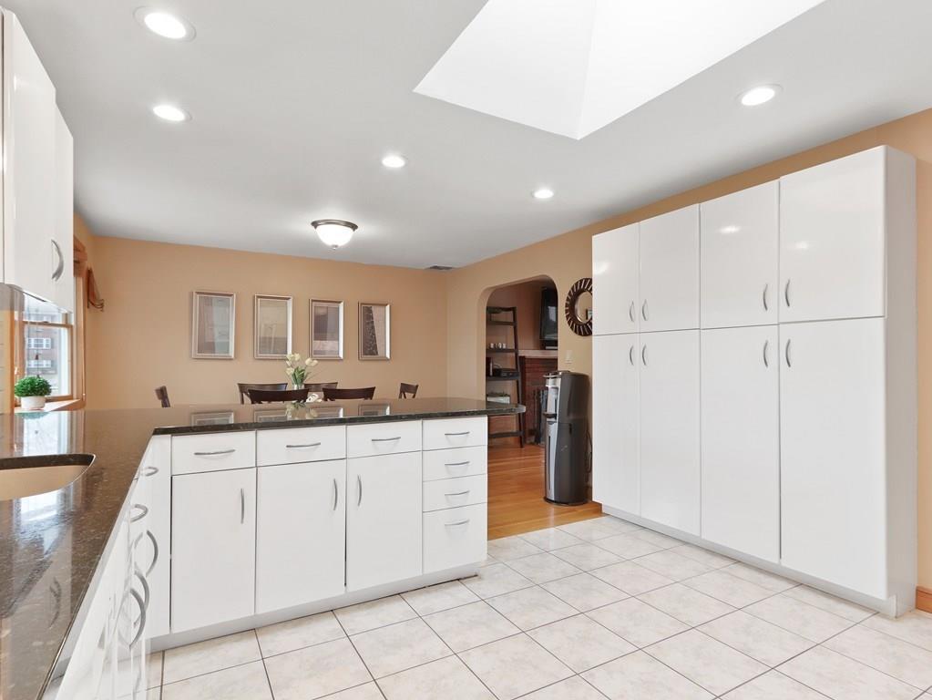 66 Anthony Road Newton, MA 02460 - Photo 11 of 39 a kitchen with white cabinets and refrigerator