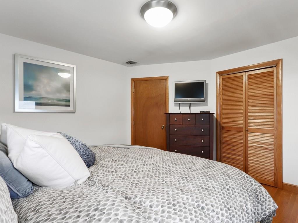 66 Anthony Road Newton, MA 02460 - Photo 19 of 39 a bedroom with a bed and a flat screen tv