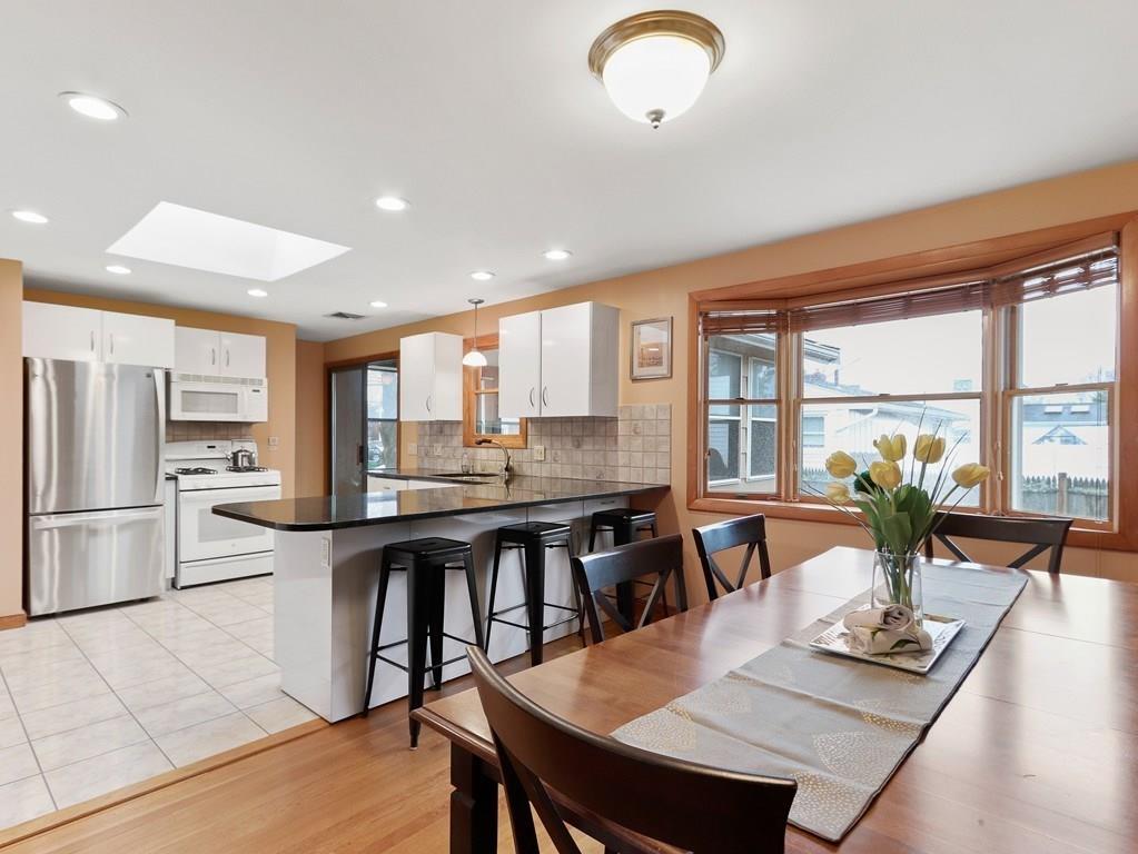66 Anthony Road Newton, MA 02460 - Photo 3 of 39 a kitchen with a table chairs refrigerator and cabinets