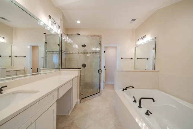 a bathroom with a tub sink and mirror