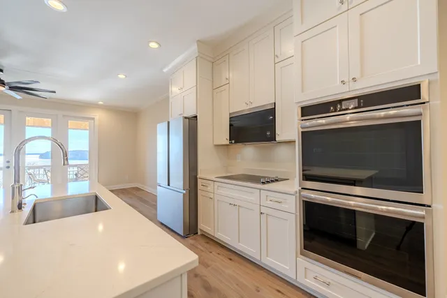 a kitchen with stainless steel appliances a stove microwave and cabinets