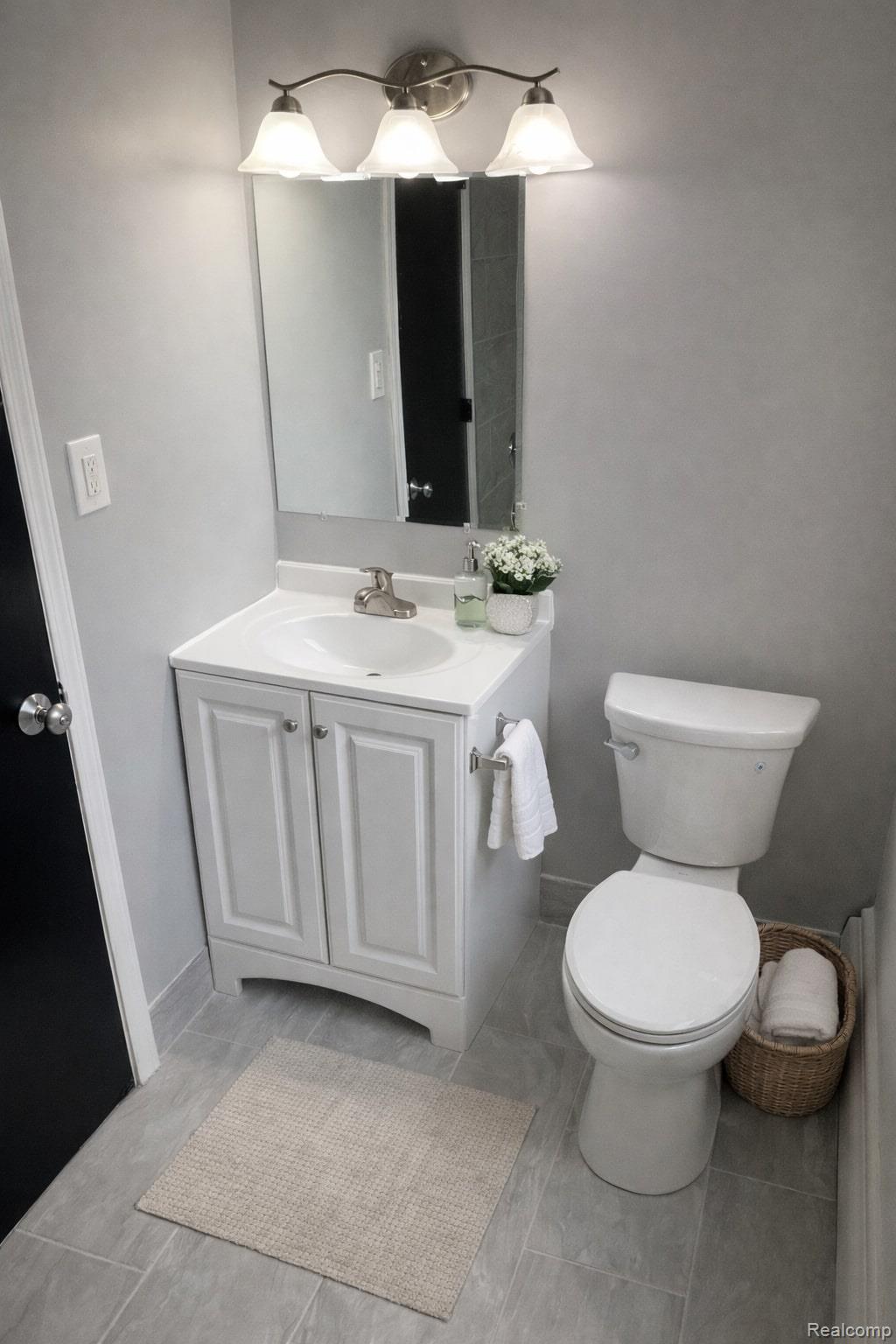 629 West Maple Road, Unit 15 Clawson, MI 48017 - Photo 8 of 10 Half bathroom with vanity and toilet