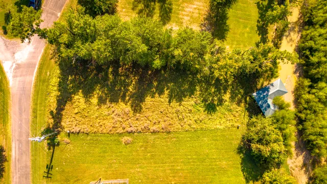 a view of beach and small yard
