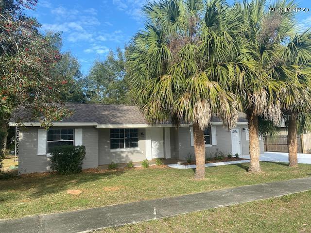 15318 Southwest 43rd Terrace Road Ocala, FL 34473 - Photo 1 of 1 a front view of a house with a garden and tree