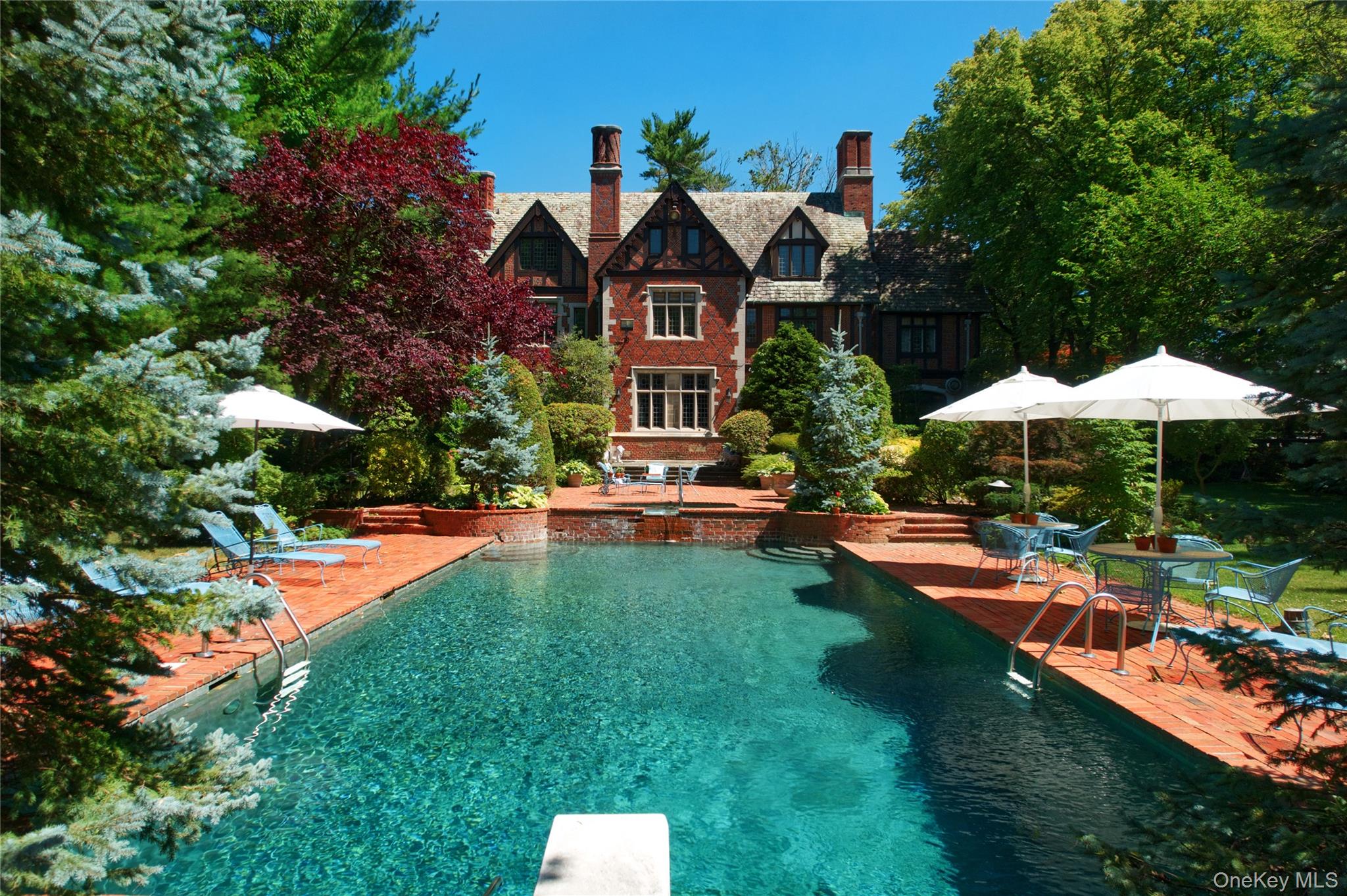 107 Bayview Road Manhasset, NY 11030 - Photo 36 of 40 a front view of a house with swimming pool having outdoor seating