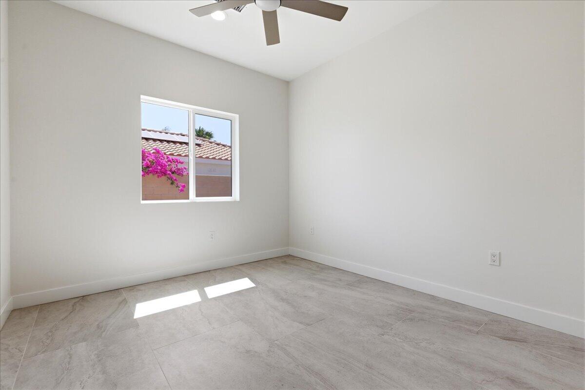 68160 Modalo Road Cathedral City, CA 92234 - Photo 22 of 57 an empty room with a ceiling fan and window