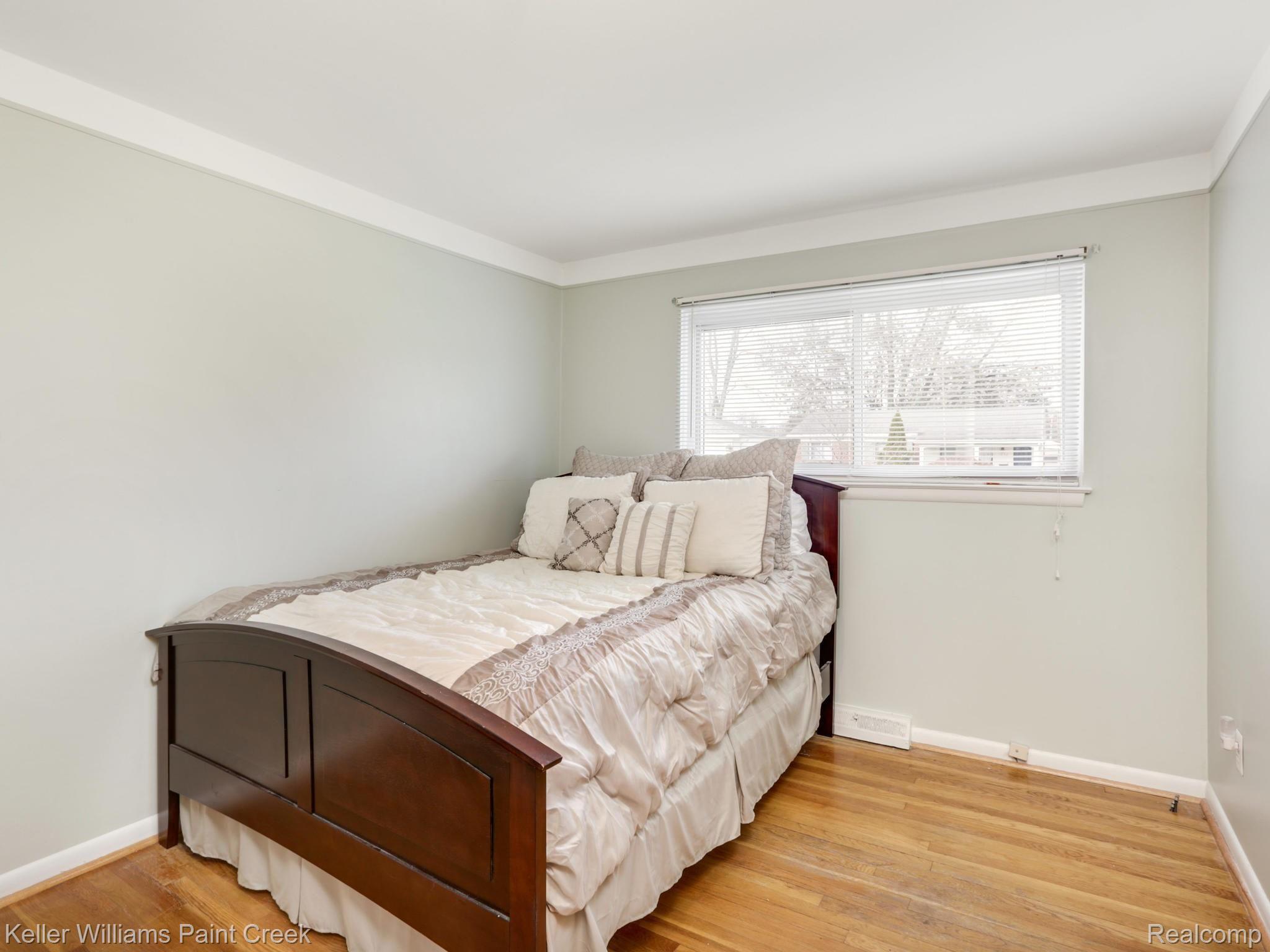 1843 Massoit Road Royal Oak, MI 48073 - Photo 9 of 17 Clean fresh decor in the first bedroom with a spacious closet and wood floors.
