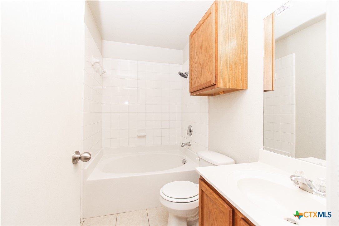 6509 Temora Loop, Unit A Killeen, TX 76549 - Photo 18 of 19 a bathroom with a sink a toilet and bathtub