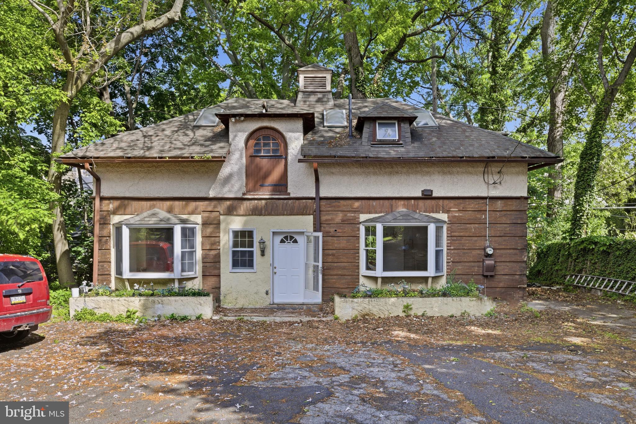 5939 Drexel Road, Unit CARRIAGE Philadelphia, PA 19131 - Photo 1 of 20 a front view of a house with a garden