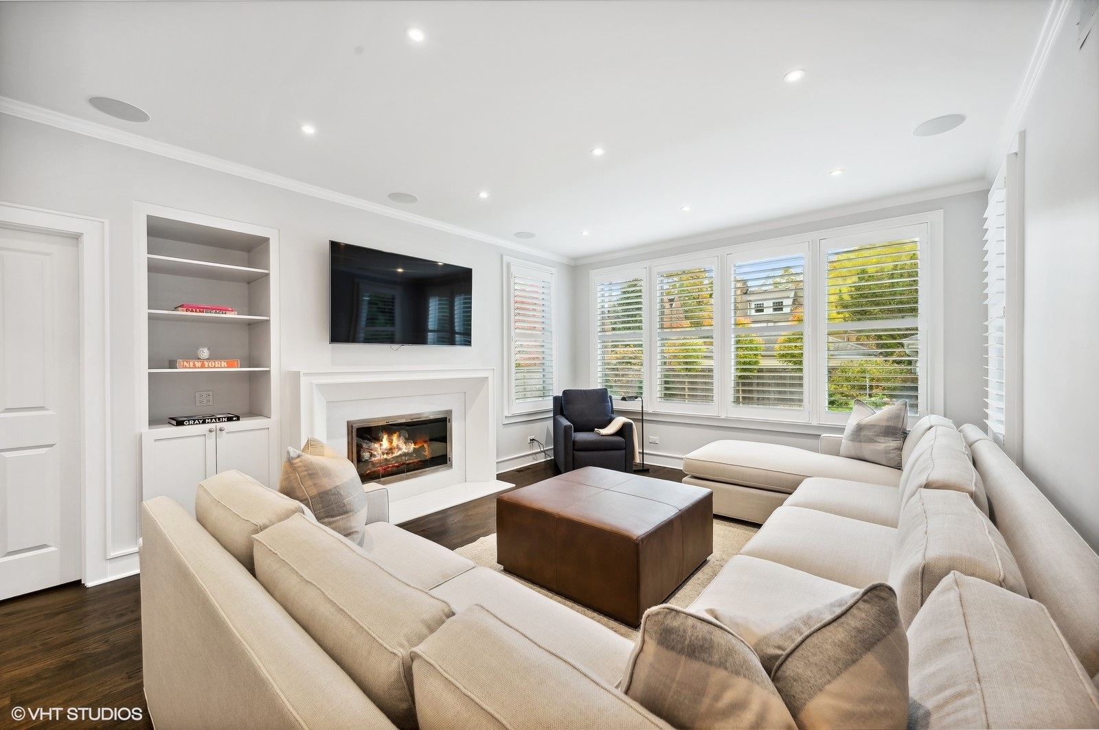 786 Locust Street Winnetka, IL 60093 - Photo 11 of 46 a living room with furniture a fireplace and a flat screen tv