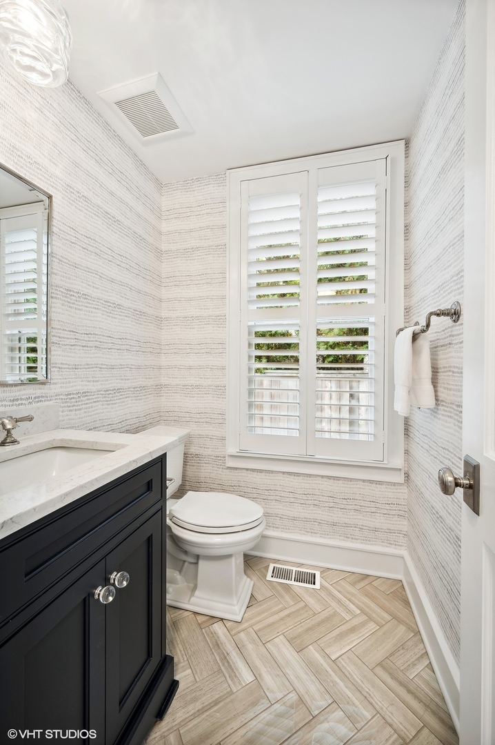 786 Locust Street Winnetka, IL 60093 - Photo 18 of 46 a bathroom with a sink a toilet a window and shower