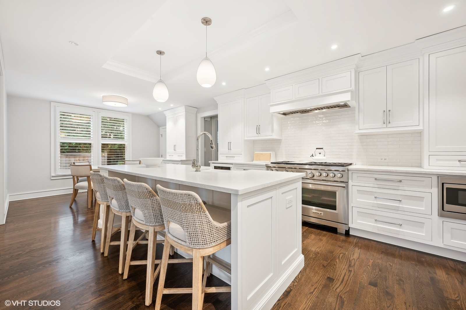 786 Locust Street Winnetka, IL 60093 - Photo 8 of 46 a kitchen with stainless steel appliances a stove a sink island white cabinetry and cabinets