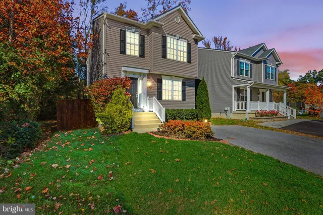 a front view of a house with a yard and porch