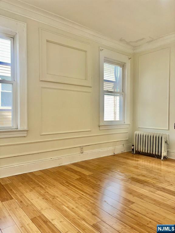 187 Shephard Avenue, Unit 1 Newark, NJ 07112 - Photo 11 of 18 a view of an empty room with wooden floor and a window