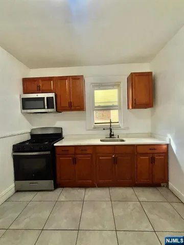 a kitchen with stainless steel appliances granite countertop a stove and a sink