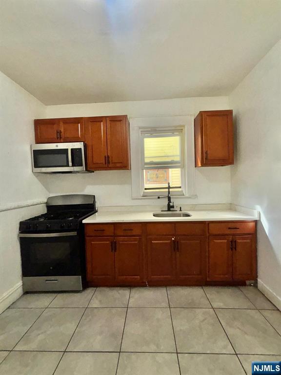 187 Shephard Avenue, Unit 1 Newark, NJ 07112 - Photo 2 of 18 a kitchen with stainless steel appliances granite countertop a stove and a sink