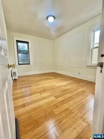 a view of a room with wooden floor and cabinet