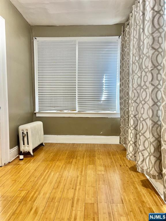 187 Shephard Avenue, Unit 1 Newark, NJ 07112 - Photo 6 of 18 a bathroom with a granite countertop window and a shower