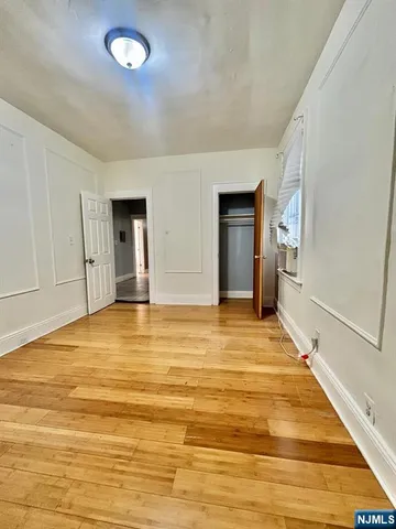 a view of a room with wooden floor and pool table