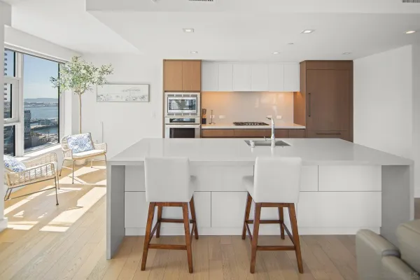 a large white kitchen with a large window