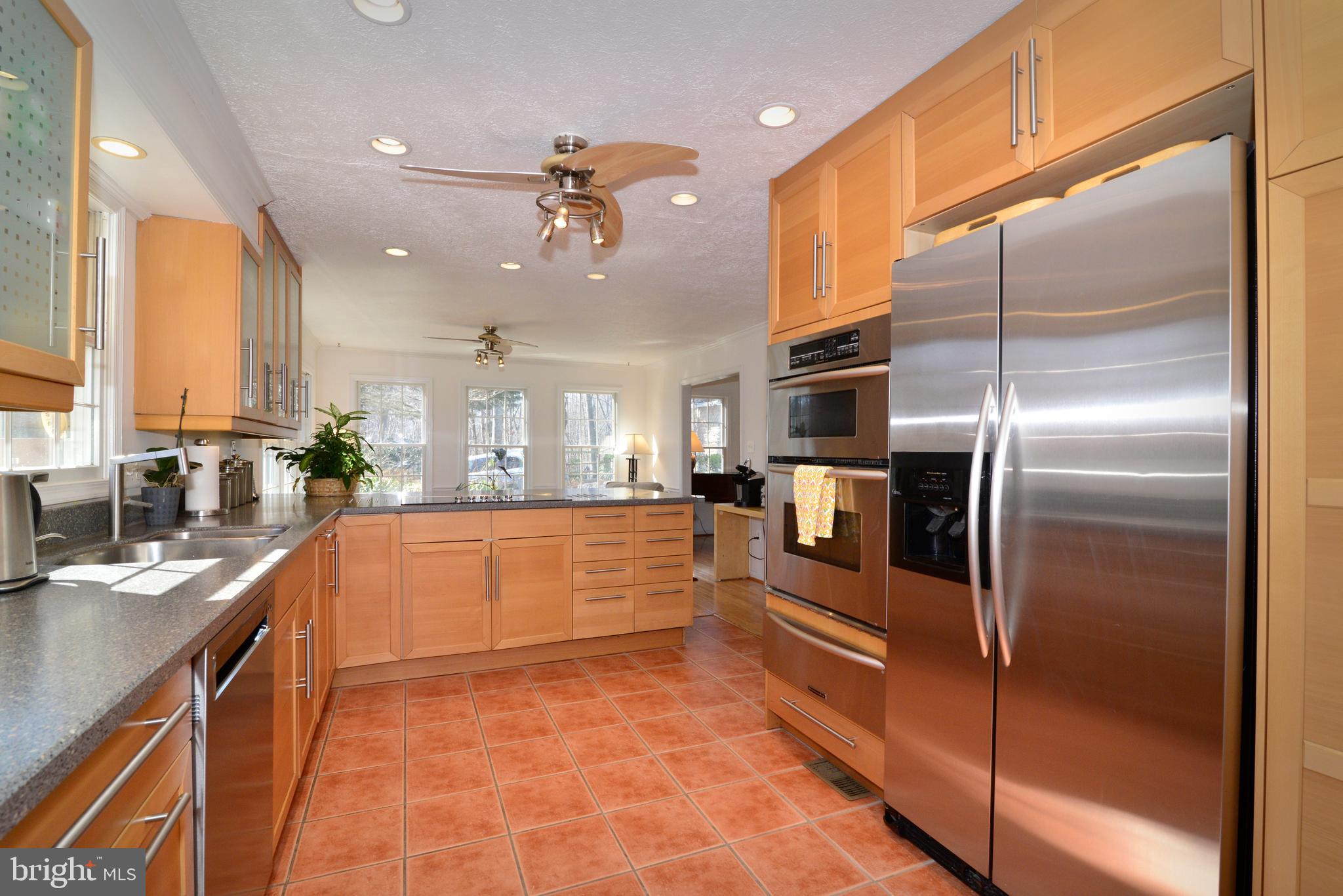 1966 Barton Hill Road Reston, VA 20191 - Photo 17 of 52 a large kitchen with stainless steel appliances kitchen island granite countertop a refrigerator a stove a sink and dishwasher